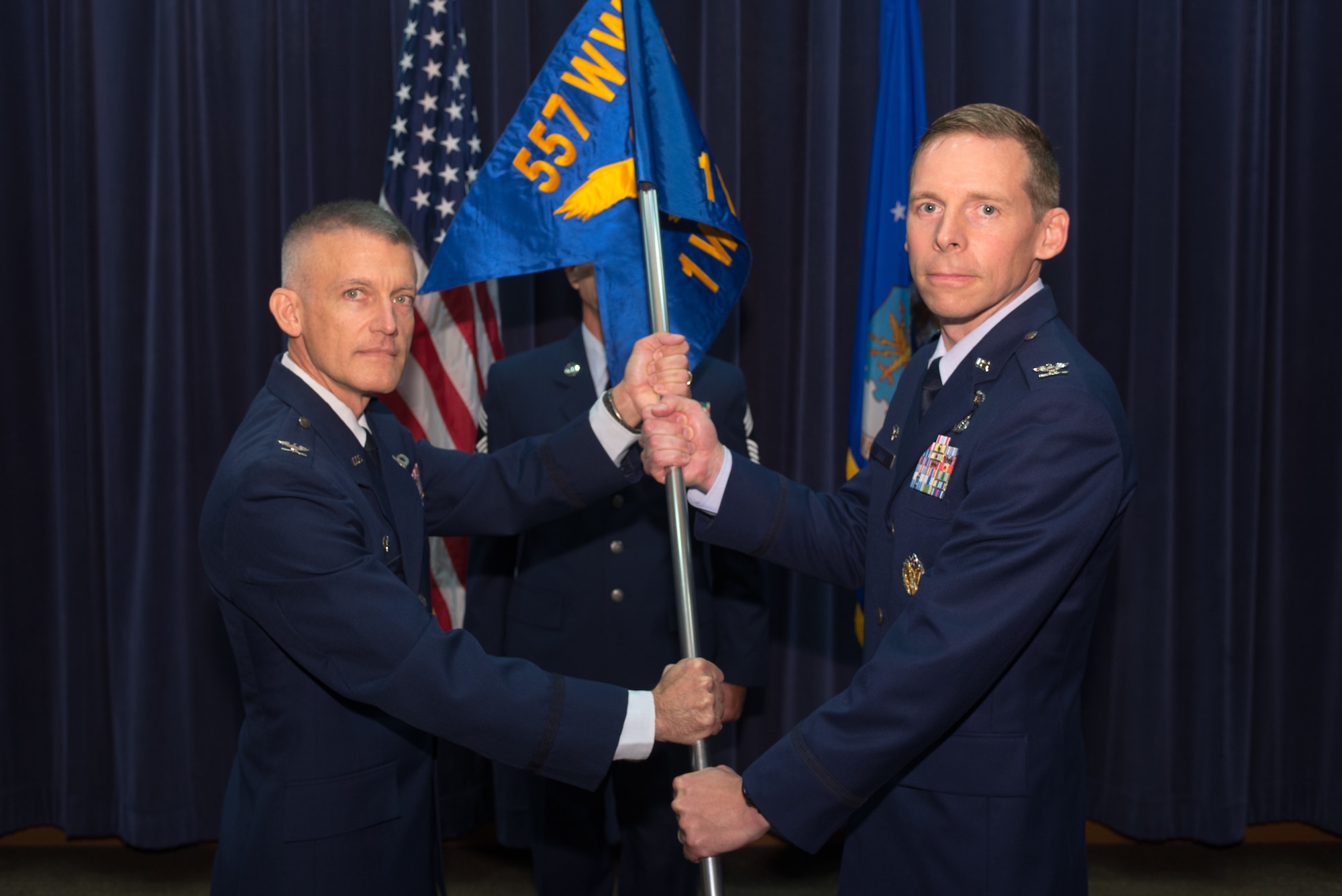 U.S. Air Force Col. Travis Steen, 1st Weather Group (WXG) commander, assumes command of the 1st WXG from U.S. Air Force Col. Brian Pukall, 557th Weather Wing commander, July 24, 2018, at Offutt Air Force Base, Nebraska. Steen was previously assigned to Offutt AFB from 1999-2002 and was the officer in charge of radar meteorology applications when the 557th WW was still the Air Force Weather Agency. (U.S. Air Force photo by Paul Shirk)