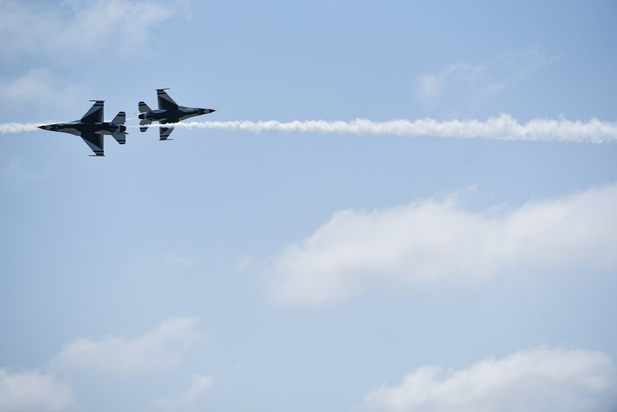 Two U.S Air Force Thunderbirds roar by during Cheyenne Frontier Days in Cheyenne, Wyo., July 25, 2018. Thunderbirds air shows are the culmination of hundreds of hours of training, maintenance, preparation and practice. The airshow provides a chance for the local community and worldwide visitors of CFD to see the U.S. Air Force in action over the skies of Cheyenne. (U.S. Air Force photo by Airman 1st Class Abbigayle Wagner)