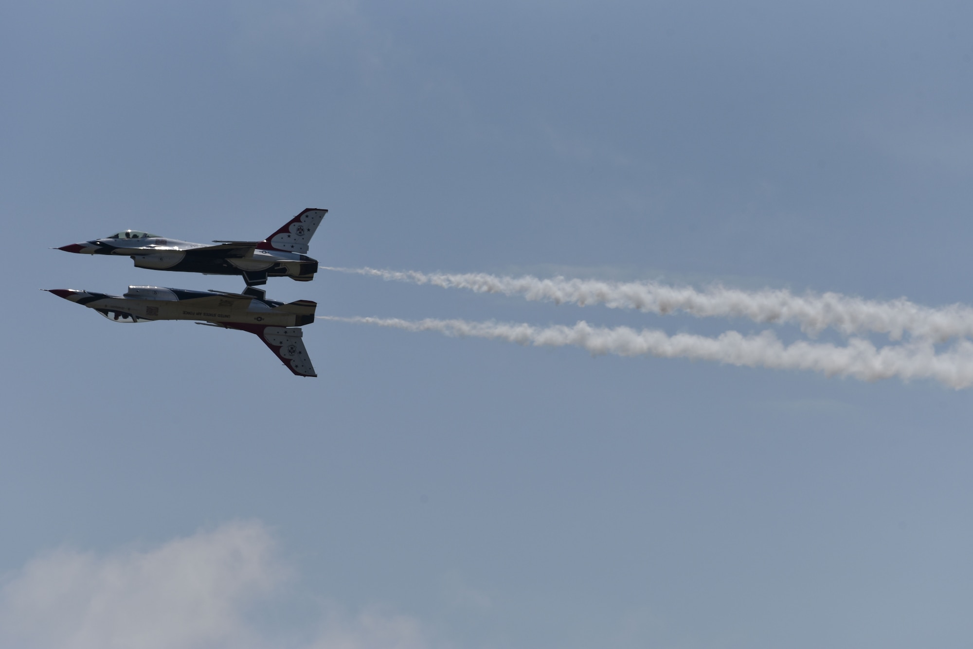 U.S. Air Force Thunderbirds perform a reflection pass stunt during Cheyenne Frontier Days, July 25, 2018, in Cheyenne, Wyo. The Thunderbirds fly closely in formation and make close passes at intense speeds during their shows showcasing their skills as an aerial acrobatics team. The airshow provides a chance for the local community and worldwide visitors of CFD to see the U.S. Air Force in action over the skies of Cheyenne. (U.S. Air Force photo by Airman 1st Class Braydon Williams)