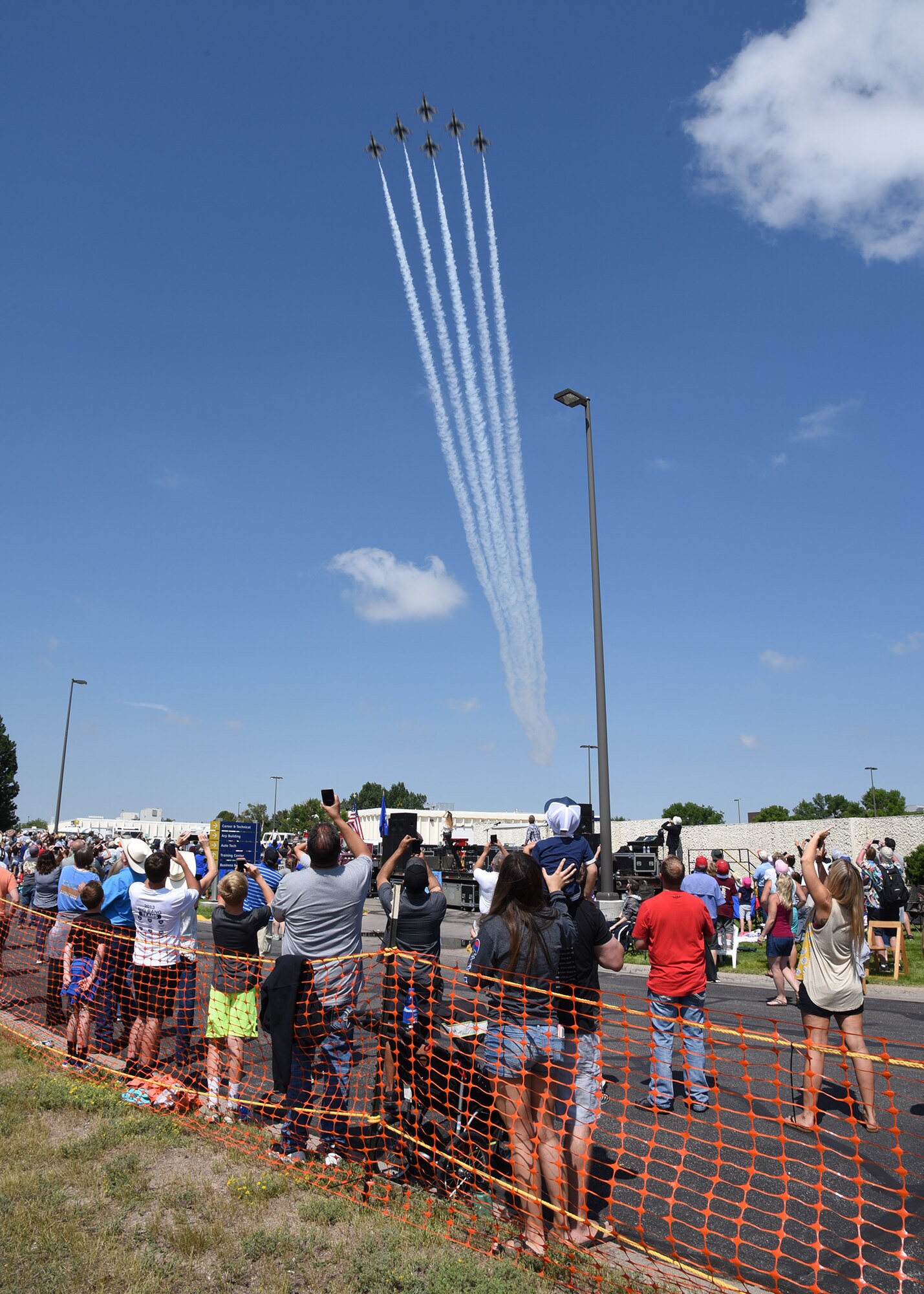 Spectators look up as the Thunderbirds roar through the sky during the Cheyenne Frontier Days air show in Cheyenne, Wyo., July 25, 2018. The Thunderbirds made their CFD flying debut in 1953 and this air show has been a staple of the annual CFD events. The airshow provides a chance for the local community and worldwide visitors of CFD to see the U.S. Air Force in action over the skies of Cheyenne. (U.S. Air Force photo by Glenn S. Robertson)