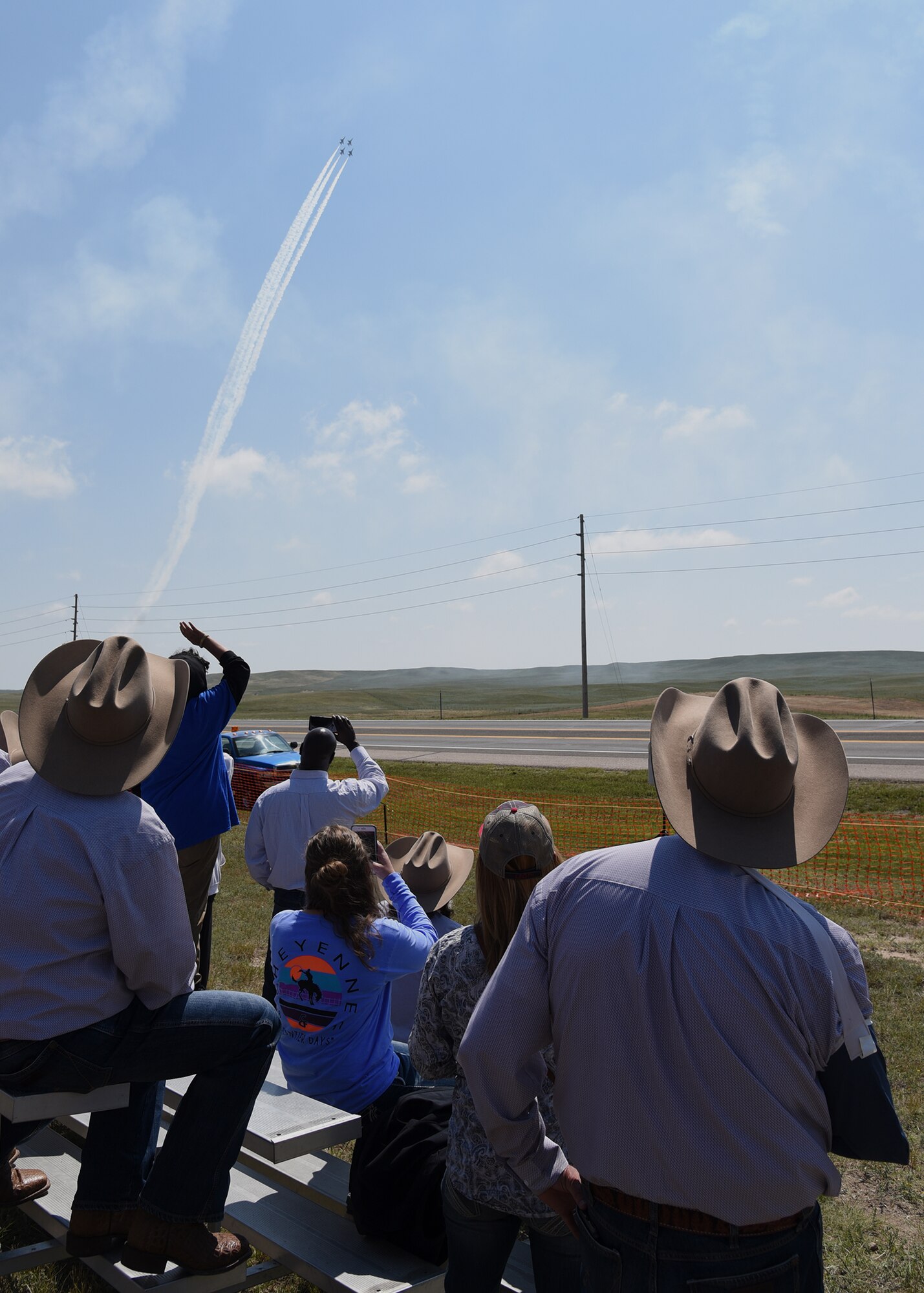 Cheyenne residents and visitors watch the U.S. Air Force Thunderbirds roar through the air during Cheyenne Frontier Days, July 25, 2018, in Cheyenne, Wyo. The Thunderbirds made their civilian air show debut at CFD in 1953. The airshow provides a chance for the local community and worldwide visitors of CFD to see the U.S. Air Force in action over the skies of Cheyenne. (U.S. Air Force photo by Glenn S. Robertson)