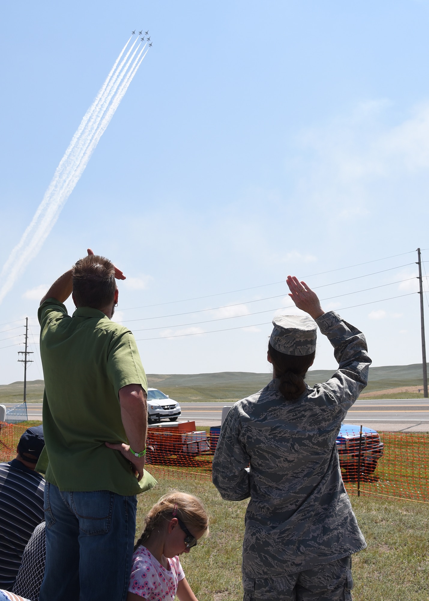 Colonel Stacy Jo Huser, 90th Missile Wing Commander, and spouse Tim O'Hara, watch the U.S. Air Force Thunderbirds perform a Delta formation during the Cheyenne Frontier Days Air Show in Cheyenne, Wyo., July 25, 2018. The Thunderbirds performed stunts such as the calypso pass and a maneuver in tribute to America's veterans and fallen heroes. The airshow provides a chance for the local community and worldwide visitors of CFD to see the U.S. Air Force in action over the skies of Cheyenne. (U.S. Air Force photo by Glenn S. Robertson)