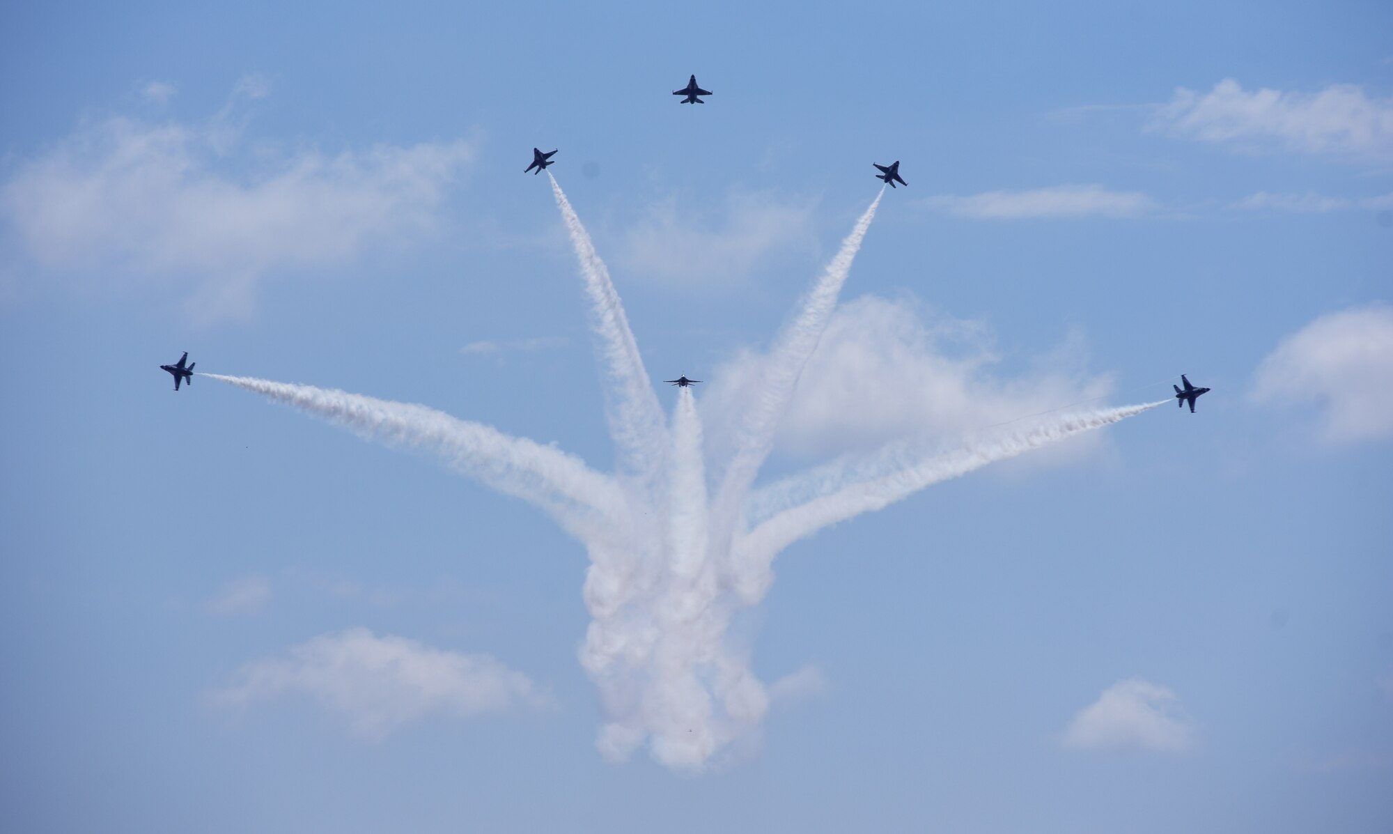 U.S. Air Force Thunderbirds perform a delta burst maneuver during Cheyenne Frontier Days, July 25, 2018, in Cheyenne, Wyo. The Thunderbirds are an Air Combat Command unit composed of eight pilots, including six demonstration pilots, four support officers, three civilians and more than 130 enlisted personnel performing in 25 career fields. The airshow provides a chance for the local community and worldwide visitors of CFD to see the U.S. Air Force in action over the skies of Cheyenne. (U.S. Air Force photo by Senior Airman Breanna Carter)