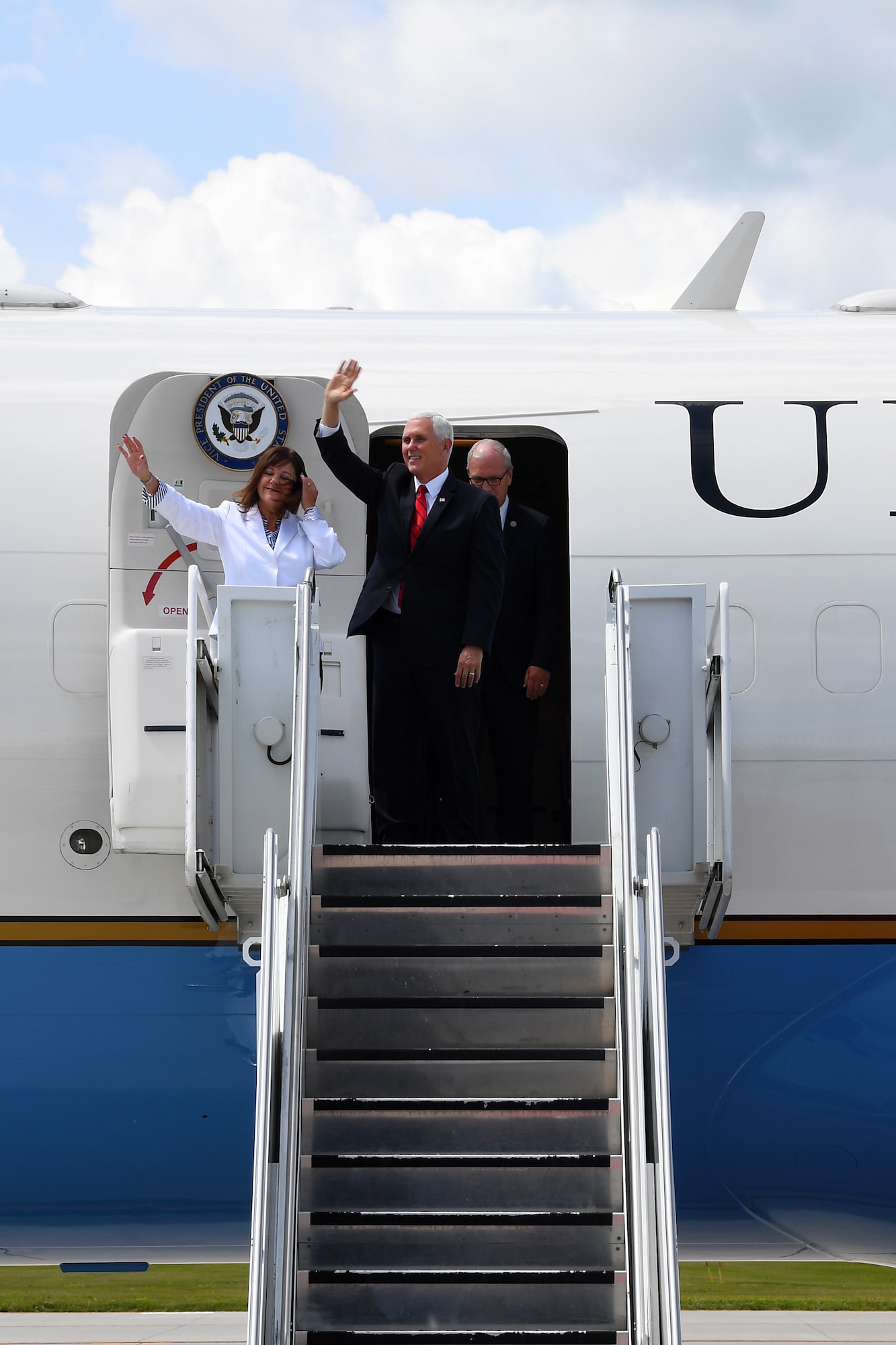 Vice President of the United States Michael Pence and his wife, Karen Pence, second lady of the United States, egress the C-32 Air Force Two July 25, 2018, on Grand Forks Air Force Base, North Dakota. Mrs. Pence sat down with spouses of Airmen to discuss quality of life improvements, and the vice president learned more about the Airmen of Grand Forks AFB and the RQ-4 Global Hawk mission before thanking a crowd of Airmen. (U.S. Air Force photo by Airman 1st Class Elora J. Martinez)