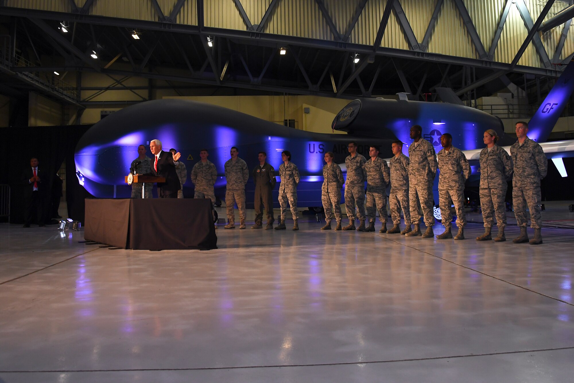 Vice President of the United States Michael Pence stands in front of Airmen during a speech to Warriors of the North July 25, 2018, on Grand Forks Air Force Base, North Dakota. Before speaking to the troops, Pence visited the Global Hawk Operations Center in addition to receiving a mission brief about the RQ-4 Global Hawk capabilities from the 348th Reconnaissance Squadron. (U.S. Air Force photo by Airman 1st Class Elora J. Martinez)