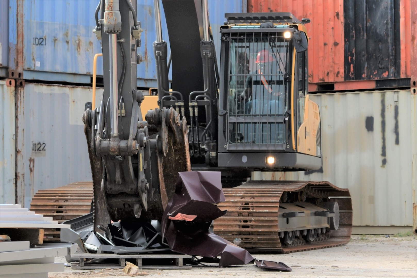 A participant in this year’s Overseas Contingency Operations Readiness Training uses heavy equipment to properly dispose of unused equipment June 19 at Fort Custer, Michigan. The training consisted of 62 attendees with half of them being civilians and the other half military reservists from the Navy, Army and Air Force assigned to DLA Disposition Services. Photo by Air Force Master Sgt. J. Scott Mathews.