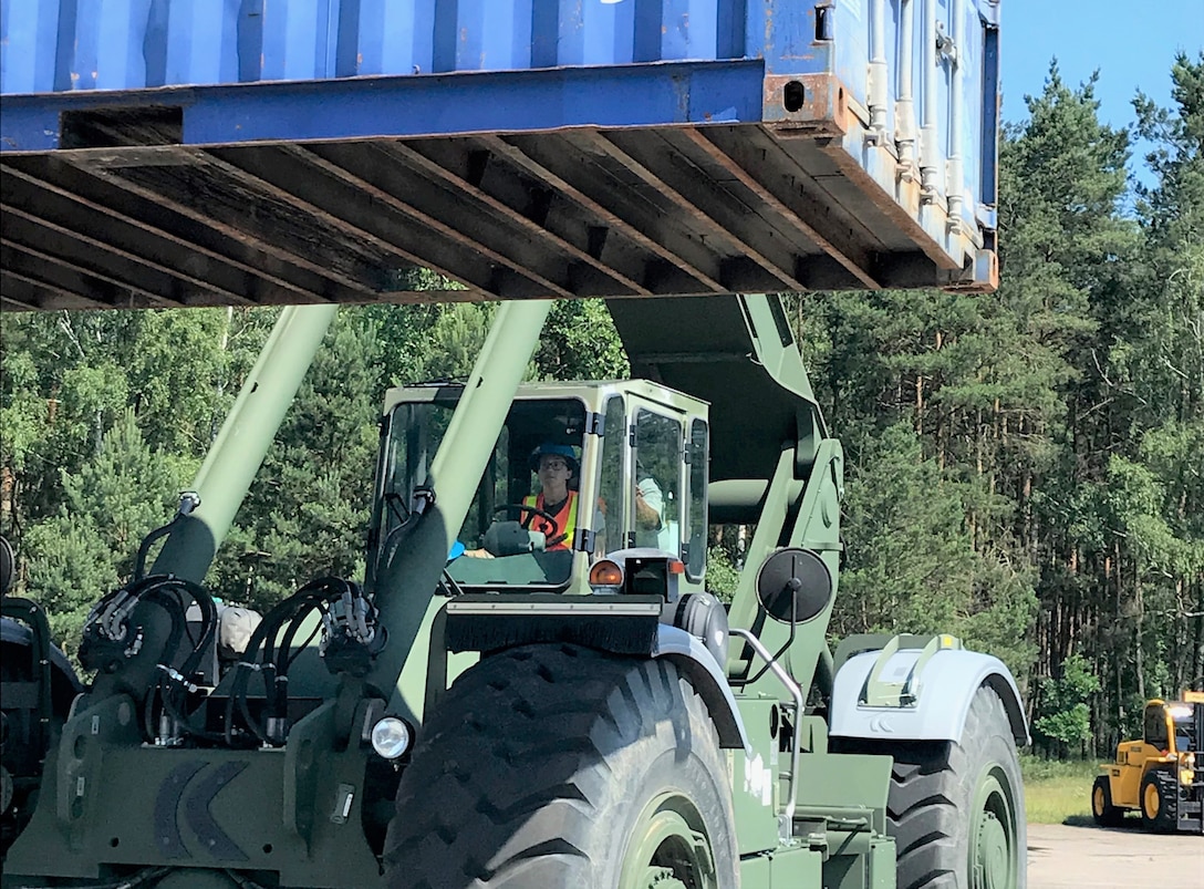 Defense Logistics Agency Reservist, Navy Logistics Specialist Petty Officer 3rd Class Mary Larkin moves a 20’ container with a Rough Terrain Container Handler at the Distribution Depot at Powidz Air Base, Poland June 4 during Saber Strike 18. Saber Strike is an annual exercise conducted at various locations throughout Poland, Estonia, Latvia and Lithuania with about 18,000 attendees from 19 different countries. This has been an annual exercise since 2010, however, it’s the first time DLA Reserve units have participated. (Photo by Navy Chief Petty Officer Michael Ruputz, Senior Enlisted Leader for DLA Expeditionary Distribution Support Unit Norfolk.)