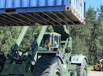 Defense Logistics Agency Reservist, Navy Logistics Specialist Petty Officer 3rd Class Mary Larkin moves a 20’ container with a Rough Terrain Container Handler at the Distribution Depot at Powidz Air Base, Poland June 4 during Saber Strike 18. Saber Strike is an annual exercise conducted at various locations throughout Poland, Estonia, Latvia and Lithuania with about 18,000 attendees from 19 different countries. This has been an annual exercise since 2010, however, it’s the first time DLA Reserve units have participated. (Photo by Navy Chief Petty Officer Michael Ruputz, Senior Enlisted Leader for DLA Expeditionary Distribution Support Unit Norfolk.)
