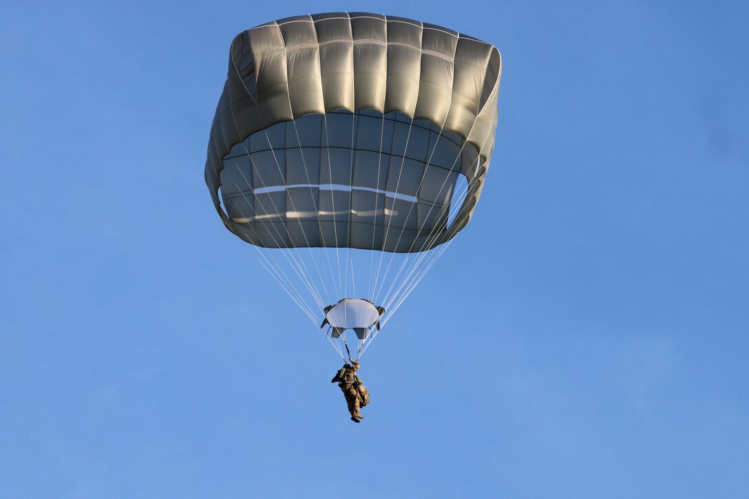 A soldier descends with a full chute to the Holland drop zone.