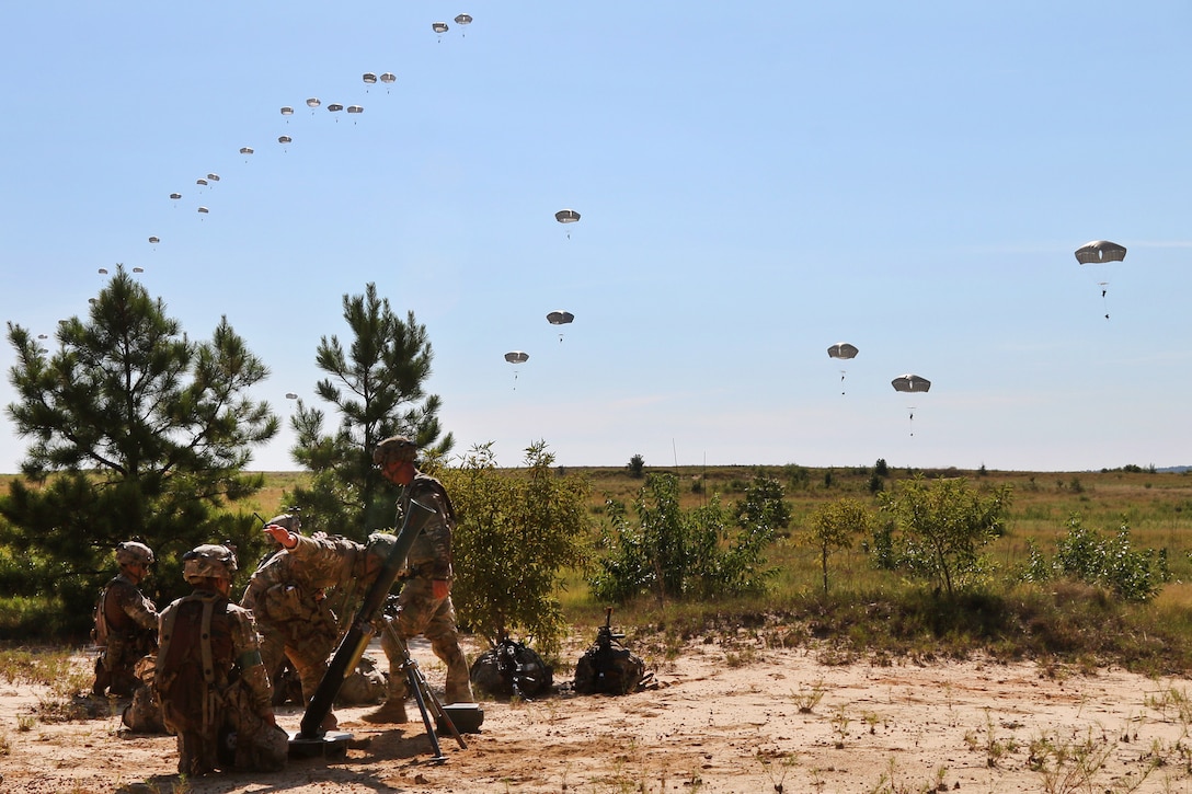 Soldiers set up an M252 81-mm mortar system.