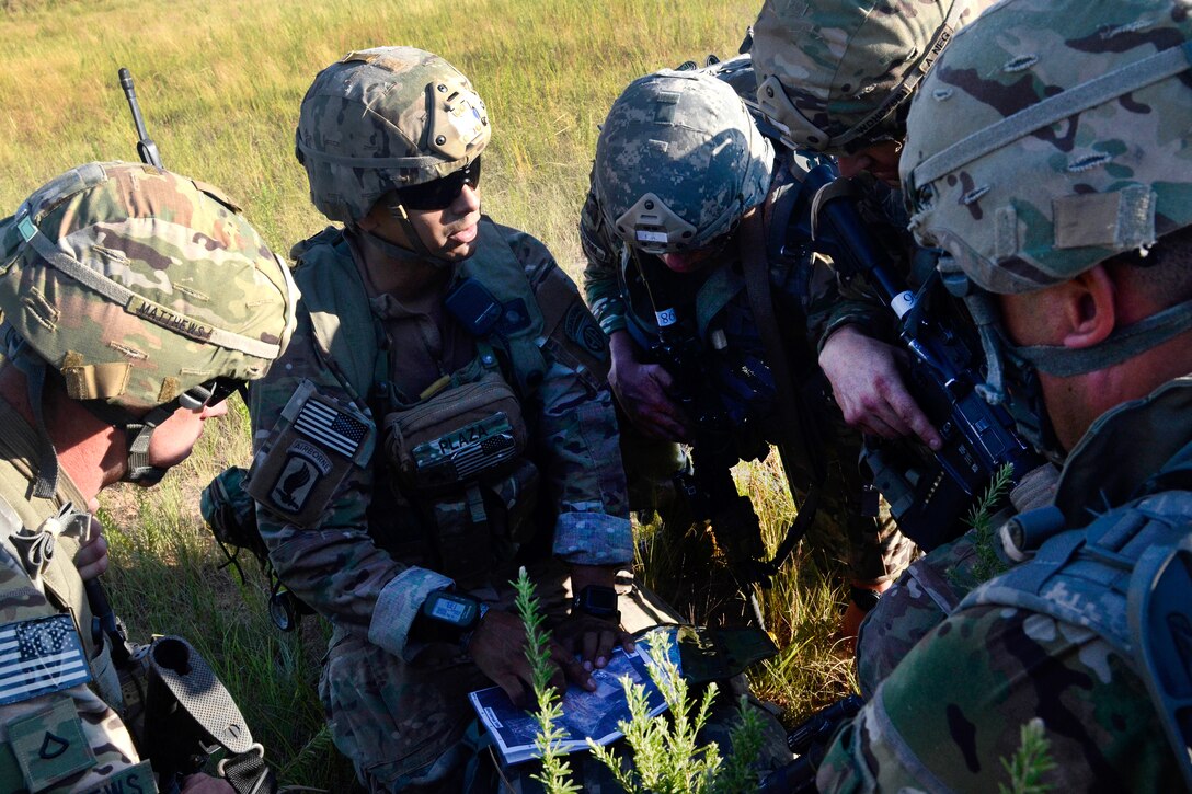 Soldiers identify their next assembly point on a map.