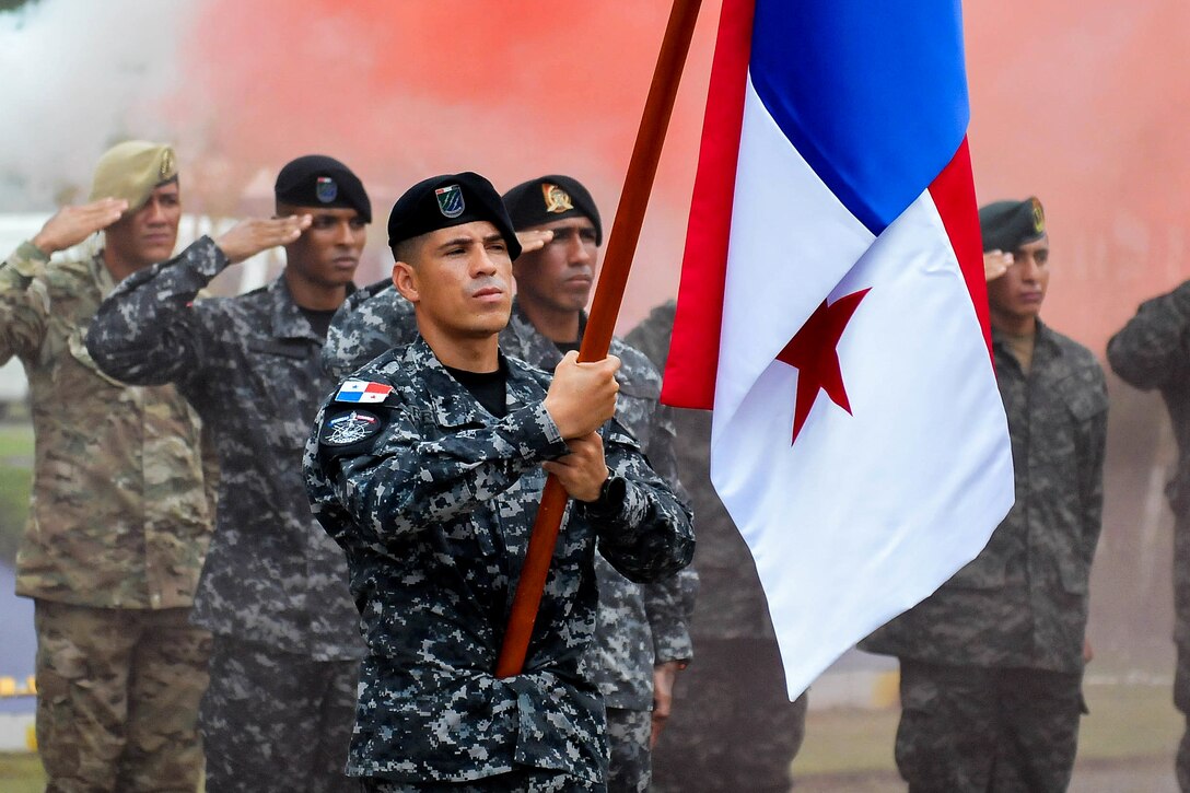 Panamanian special operations team salute during the Fuerzas Comando 2018 opening ceremony.