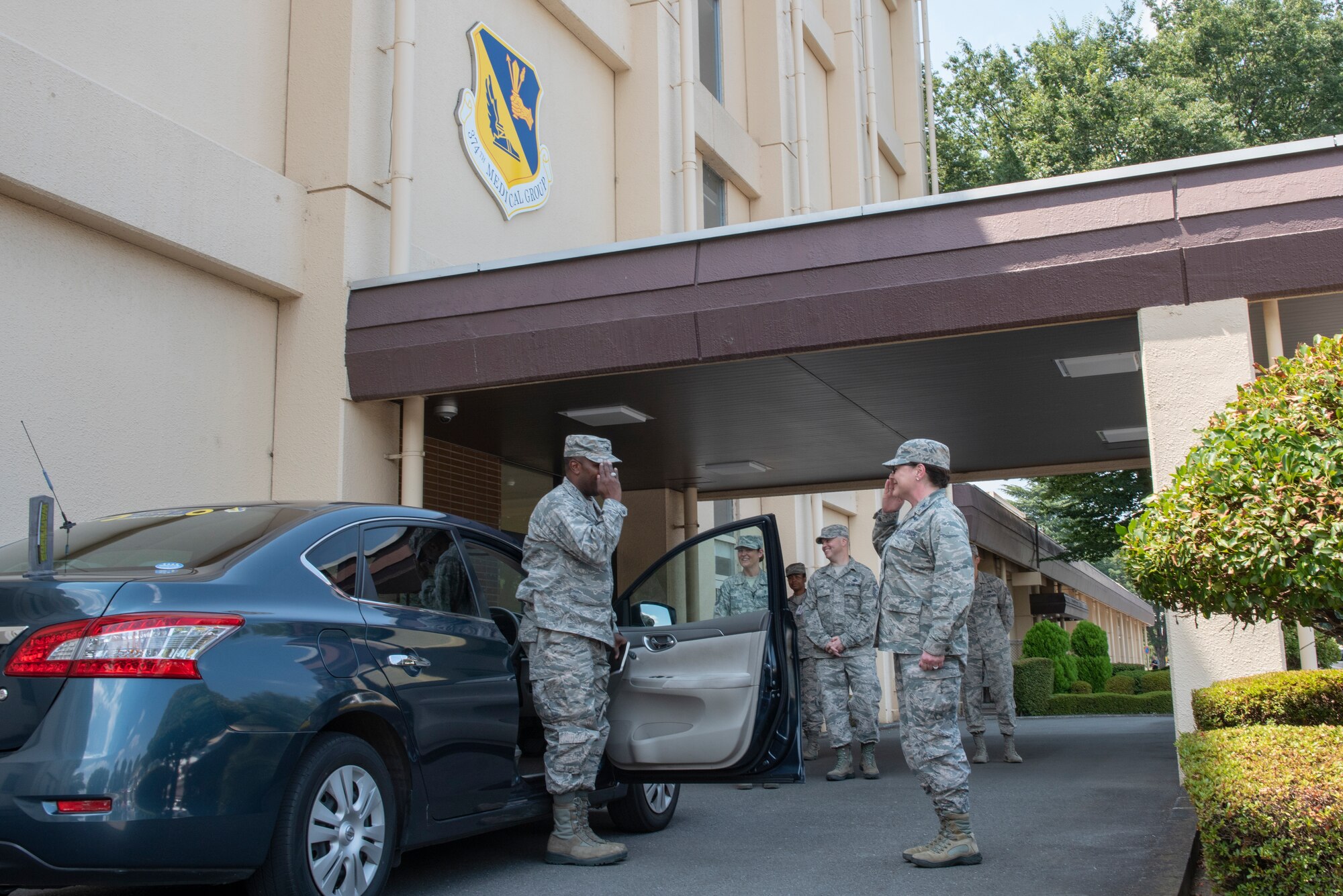 Col. Ingrid Ford, 374th Medical Group commander, salutes Col. Otis C. Jones, 374th Airlift Wing commander, upon his arrival for the 374 MDG immersion tour at Yokota Air Base, Japan, July 24, 2018.