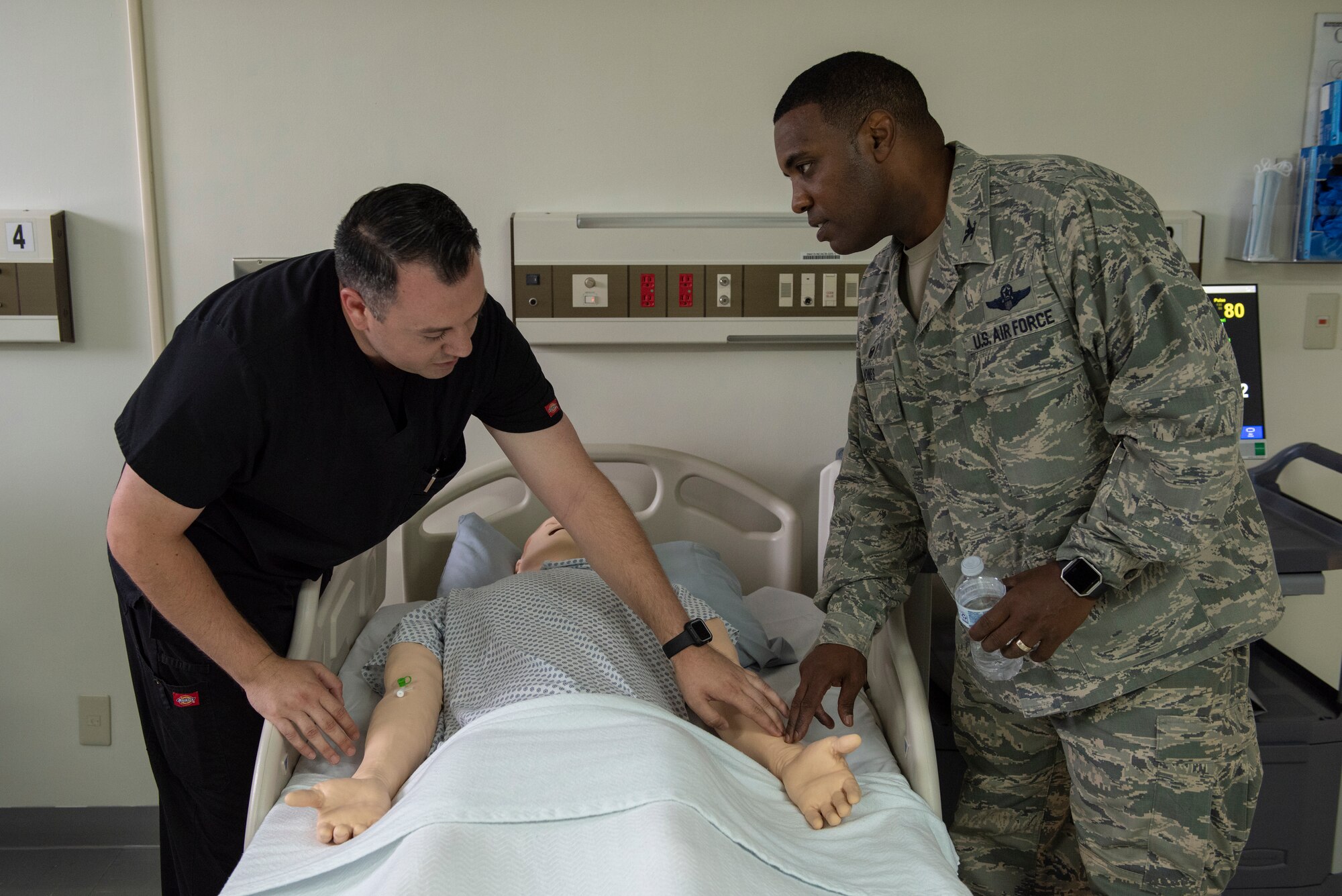 Dominic Trujillo-Hobbs, 374th Medical Group simulation operator, shows Col. Otis C. Jones, 374th Airlift Wing commander, pulse points on the SimMan 3G training tool during the 374 MDG immersion tour at Yokota Air Base, Japan, July 24, 2018.