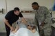 Dominic Trujillo-Hobbs, 374th Medical Group simulation operator, shows Col. Otis C. Jones, 374th Airlift Wing commander, pulse points on the SimMan 3G training tool during the 374 MDG immersion tour at Yokota Air Base, Japan, July 24, 2018.