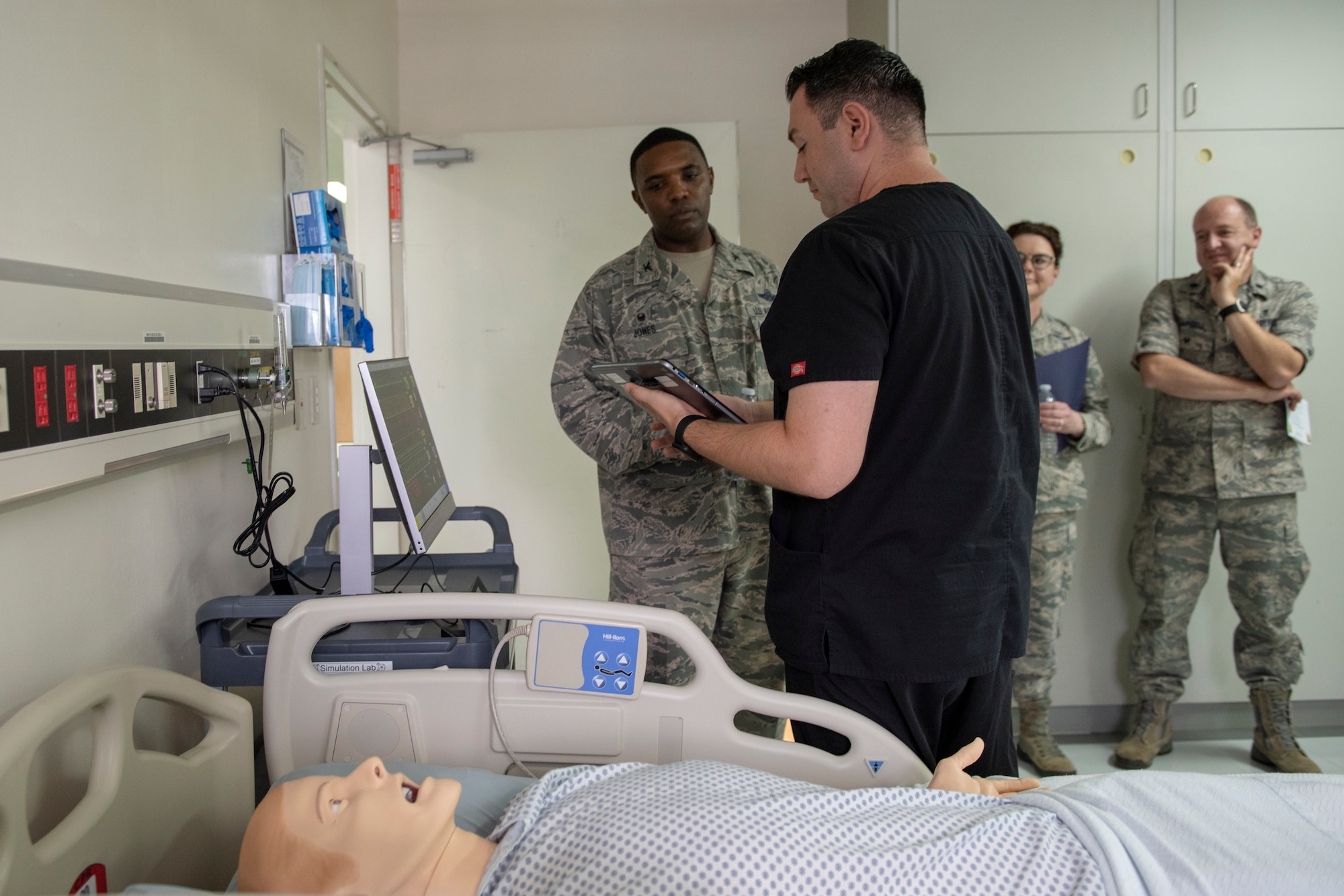 Dominic Trujillo-Hobbs, 374th Medical Group simulation operator, briefs Col. Otis C. Jones, 374th Airlift Wing commander, on the capabilities of the SimMan 3G and how it helps with medical education and training of medical personnel during the 374 MDG immersion tour at Yokota Air Base, Japan, July 24, 2018.