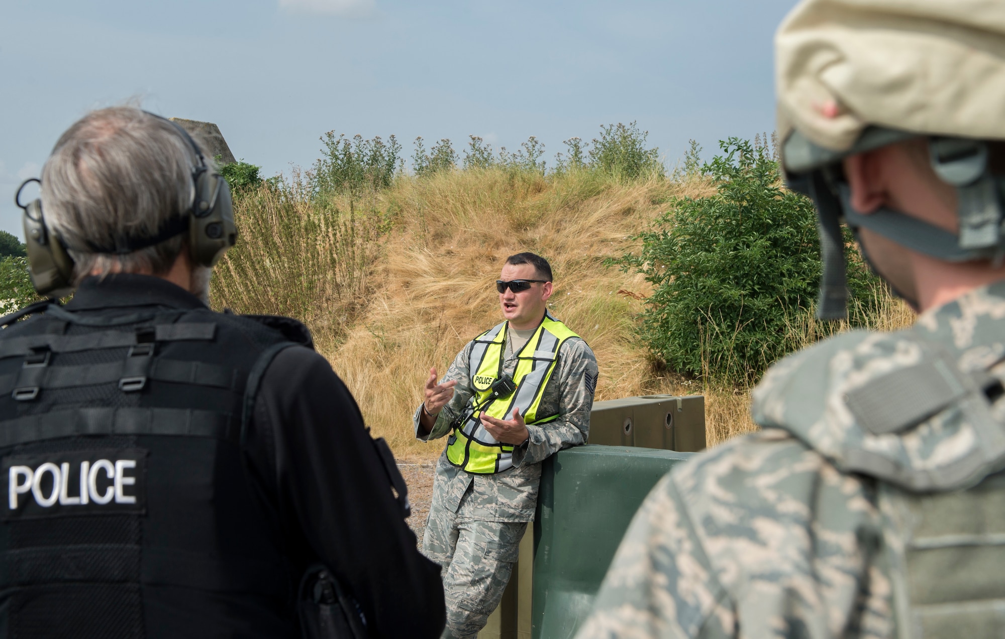 U.S. Air Force Tech. Sgt. Travis Beatty, 422nd Security Forces Squadron training manager, speaks to Airmen and Ministry of Defence personnel about the next scenario at RAF Croughton, United Kingdom, July 19, 2018. Beatty organized and oversaw the joint training scenarios. (U.S. Air Force photo by Senior Airman Chase Sousa)
