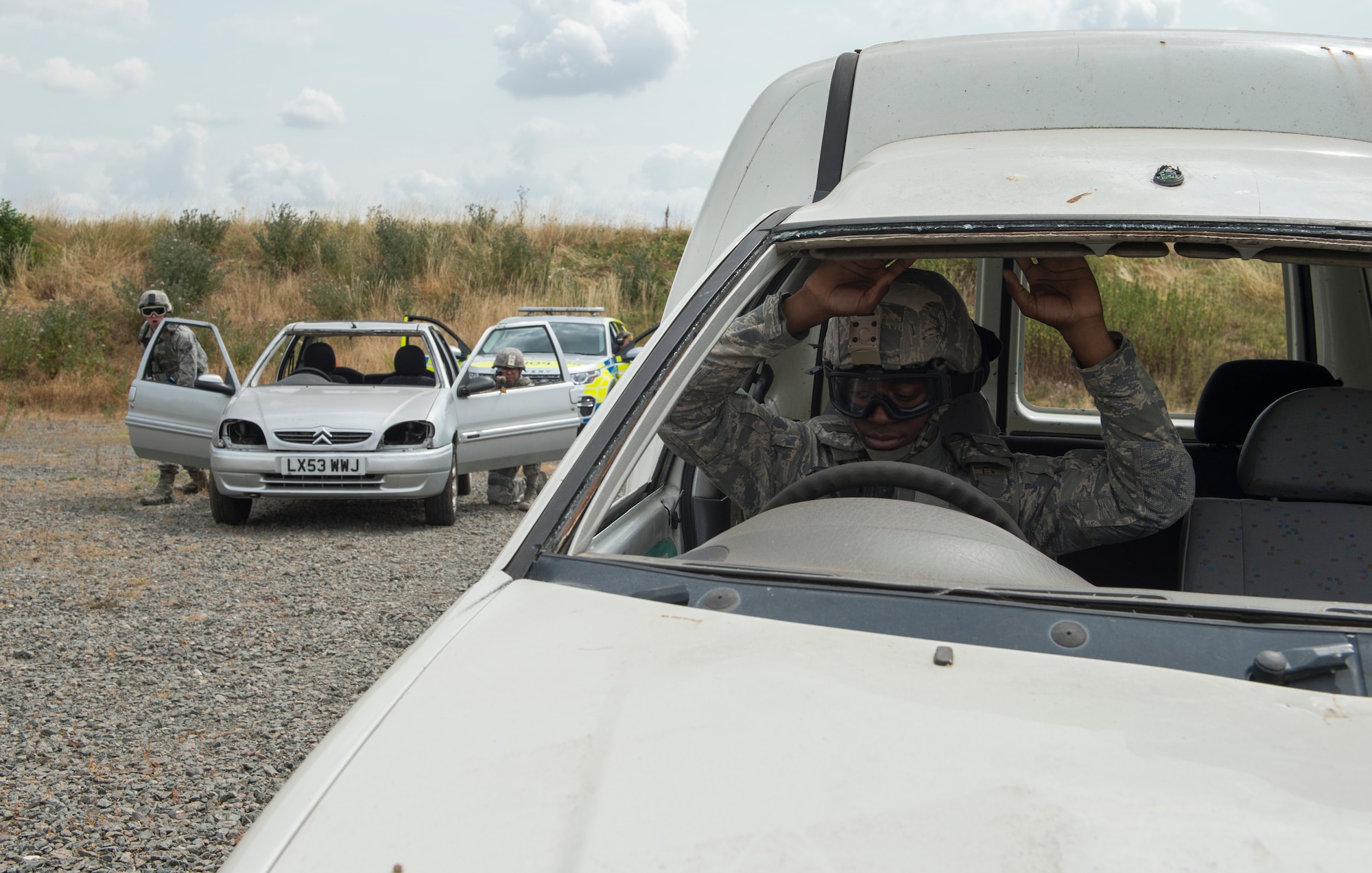 422nd Security Forces Airmen conduct a gate runner training scenario at RAF Croughton, United Kingdom, July 19, 2018. The scenario included Ministry of Defence personnel to help standardize police response. (U.S. Air Force photo by Senior Airman Chase Sousa)