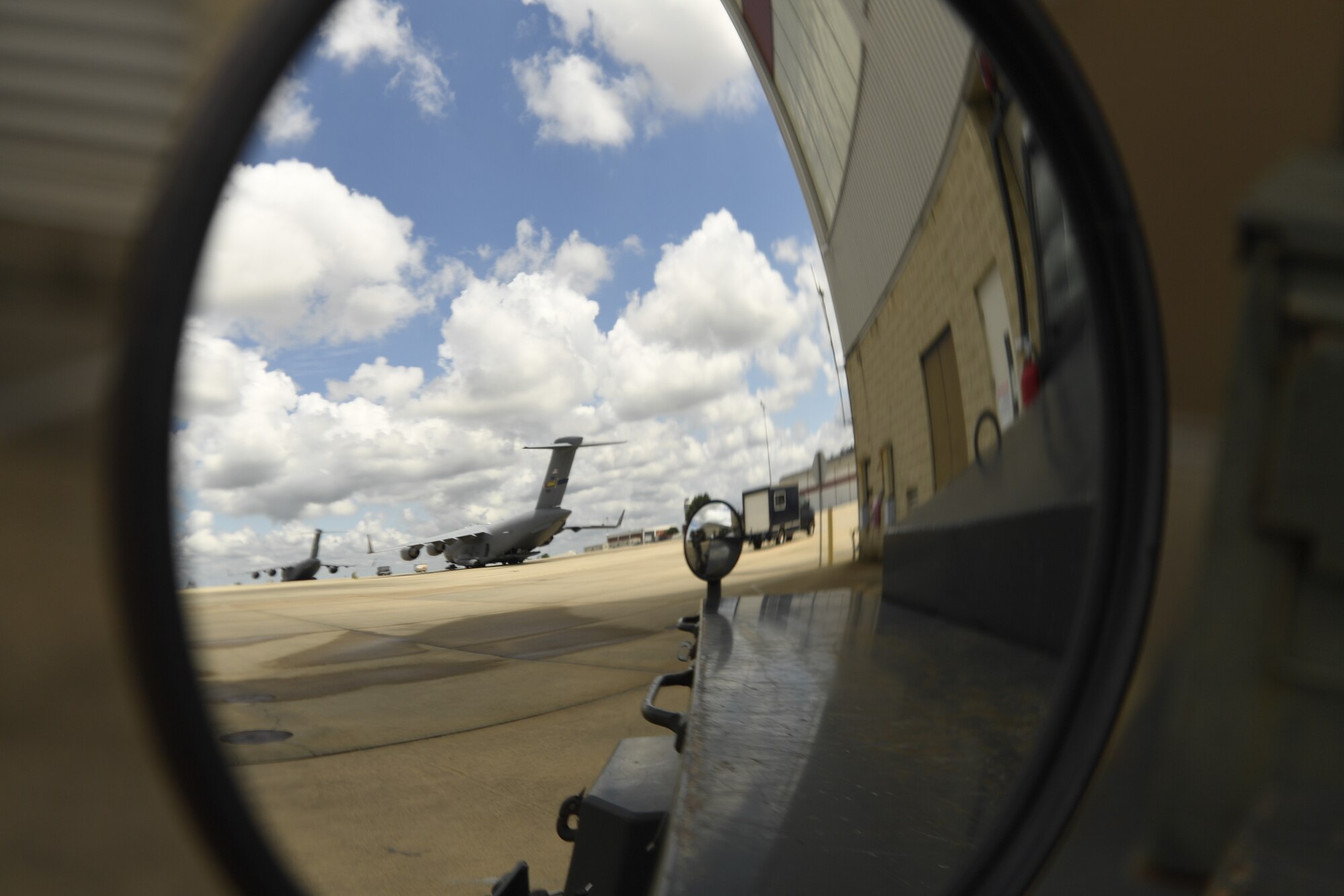 Members of the 145th Aircraft Maintenance Squadron (AMXS) prepare to tow a C-17 Globemaster III aircraft at the North Carolina Air National Guard Base, Charlotte Douglas International Airport, July 24, 2018. Since the aircraft conversion in April, the 145th AMXS is working to train maintenance personnel with a goal of them being fully qualified.