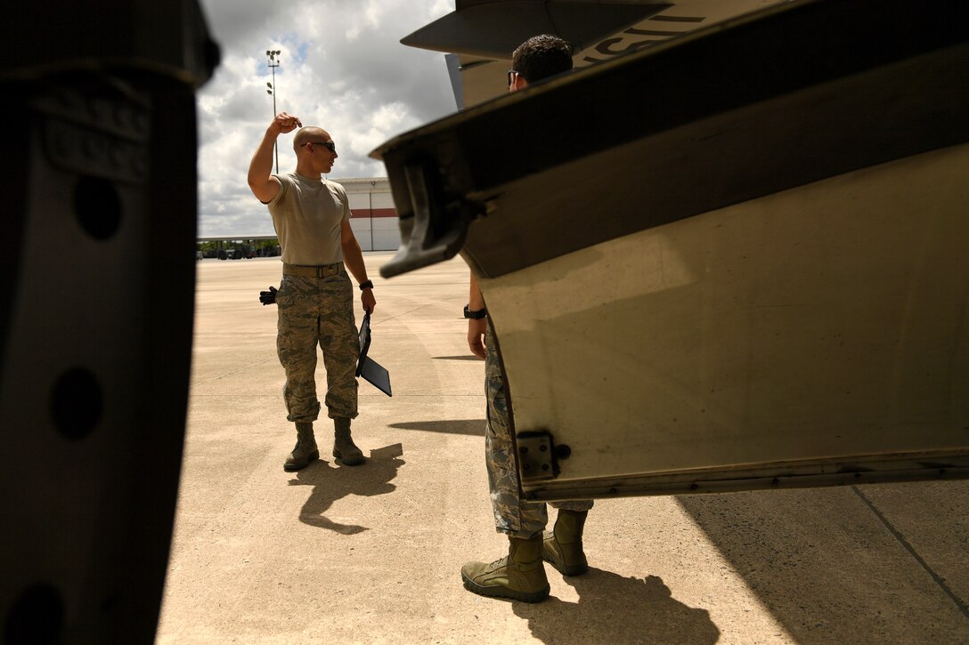 U.S. Air Force Staff Sgt. James Srackangast, 145th Aircraft Maintenance Squadron (AMXS), gives instructions to other crew chiefs in training prior to towing a C-17 Globemaster III aircraft at the North Carolina Air National Guard Base, Charlotte Douglas International Airport, July 24, 2018. Since the aircraft conversion in April, the 145th AMXS is working to train maintenance personnel with a goal of them being fully qualified.