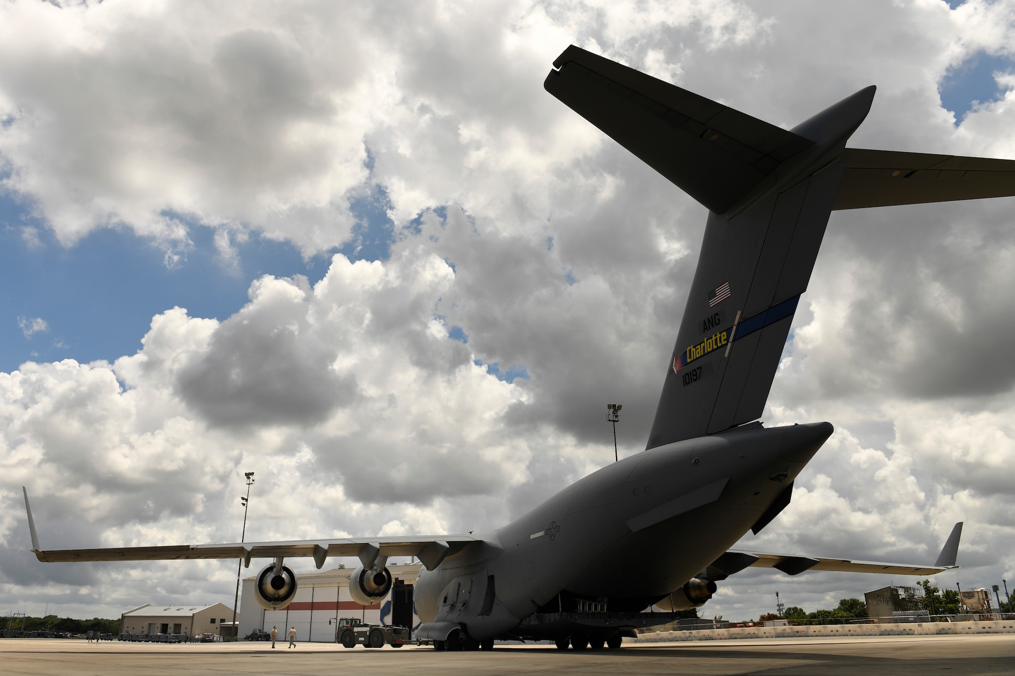 Members of the 145th Aircraft Maintenance Squadron tow a C-17 Globemaster III at the North Carolina Air National Guard Base, Charlotte Douglas International Airport, July 24, 2018. The towing process is a coordinated effort to ensure the safety of maintenance personnel and the airframe.