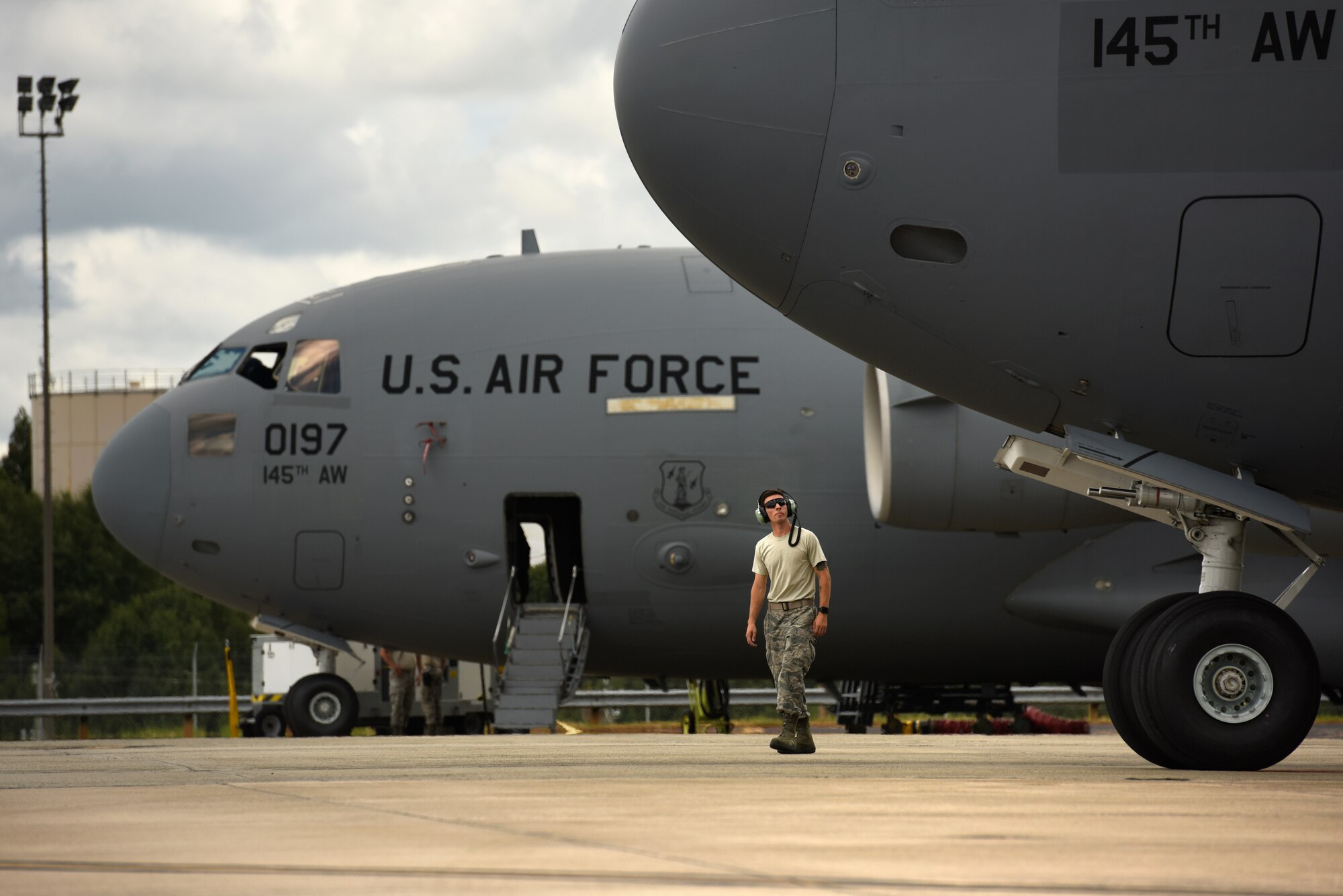 U.S. Air Force Senior Airmen Zackary Aldag, 145th Aircraft Maintenance Squadron, walks to the front of a C-17 Globemaster III at the North Carolina Air National Guard Base, Charlotte Douglas International Airport, July 24, 2018. Aldag is in upgrade training for C-17 Globemaster III aircraft after the units conversion from the C-130 Hercules aircraft and is working towards being fully qualified.