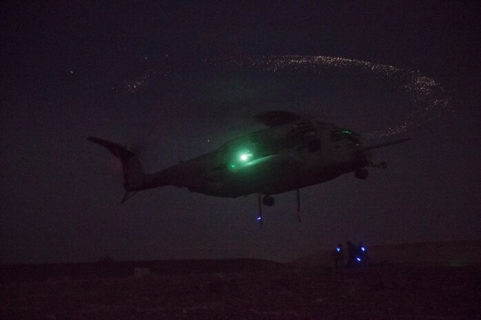 Marines with Combat Logistics Battalion 11, 1st Marine Logistics Group, prepare to attach an external load to a CH-53E Super Stallion with Marine Heavy Helicopter Squadron 462 during helicopter support team operations aboard Marine Corps Air Station Yuma, Ariz., July 19. HST operations are conducted to deliver supplies to service members who need the supplies quickly or are in difficult areas to reach via land.