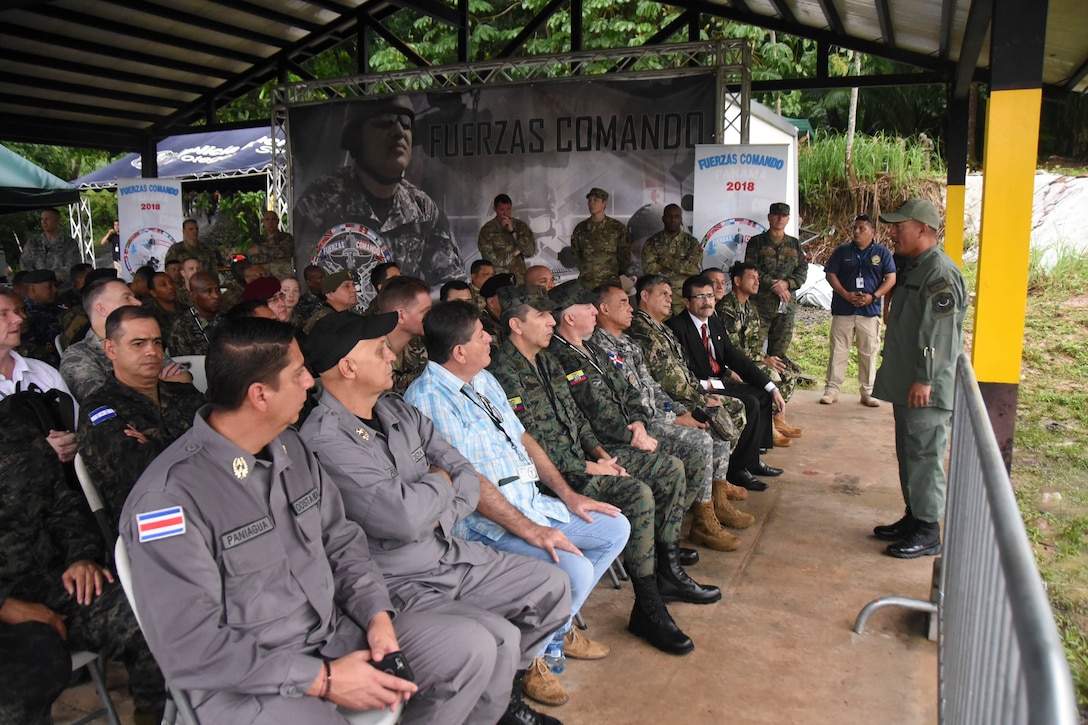 A Panamanian Police Officer briefs Senior Leaders and Distinguished Visitors before participants of Fuerzas Comando 2018