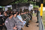 A Panamanian Police Officer briefs Senior Leaders and Distinguished Visitors before participants of Fuerzas Comando 2018