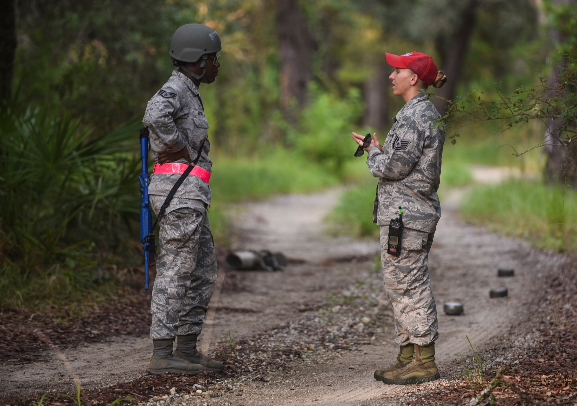 U.S. Air Force Tech. Sgt. Kelsey Keppner, Detachment 1, 823rd Rapid Engineer Deployable Heavy Operational Repair Squadron Engineers (REDHORSE) Squadron force support squadron food operations NCO in charge, right, talks to Staff Sgt. Samantha Bryan, a Silver Flag training site student from the 6th Force Support Squadron, MacDill Air Force Base, Florida, left, at the Silver Flag training site on Tyndall Air Force Base, July 19, 2018.