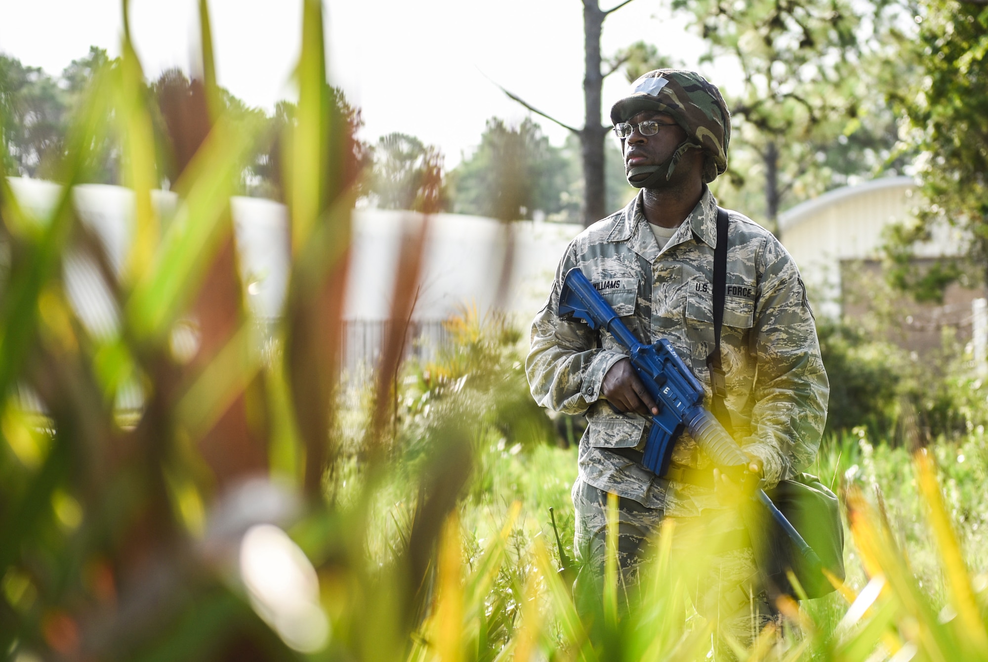 U.S. Air Force Tech. Sgt. Jean-Paul Williams, a Silver Flag training site student from the 168th Force Support Squadron, Eielson Air Force Base, Alaska, keeps watch over a building at the Silver Flag training site on Tyndall Air Force Base, Florida, July 19, 2018.