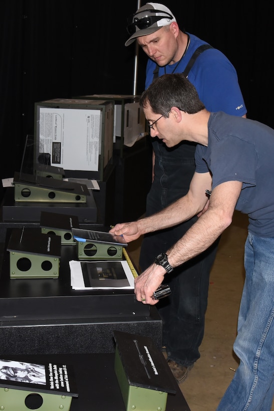 Museum Exhibit Specialists Caleb Still(R) and Mike Foster(L) prepare display cases for the Memphis Belle Exhibit in the WWII Gallery. (U.S. Air Force photo by Ken LaRock)