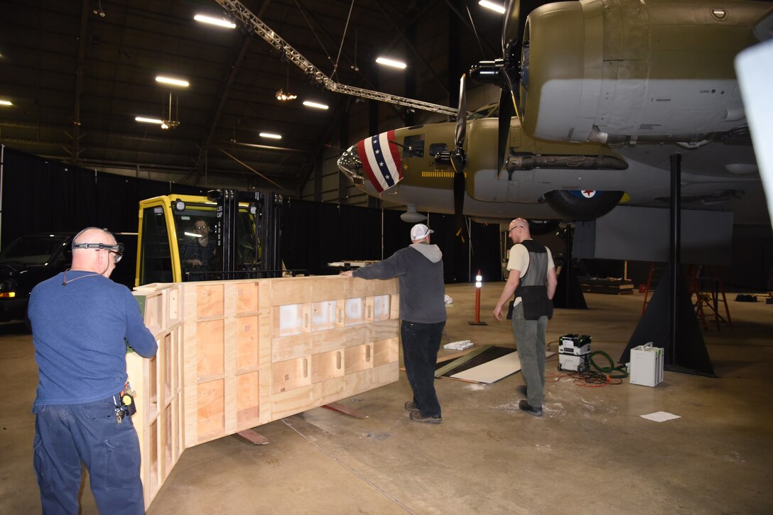 Museum Exhibits Specialists install display pieces for the Memphis Belle Exhibit in the WWII Gallery. (U.S. Air Force photo by Ken LaRock)