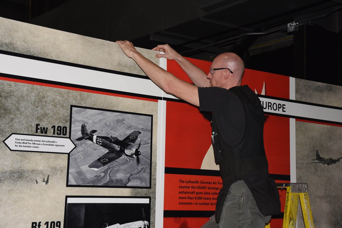 Museum Exhibits Specialist Shane Stanton prepares a wall panel for display in the WWII Gallery. (U.S. Air Force photo by Ken LaRock)