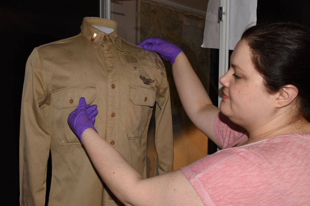 Museum Conservator Jennifer Myers prepares artifacts for display in the WWII Gallery. 