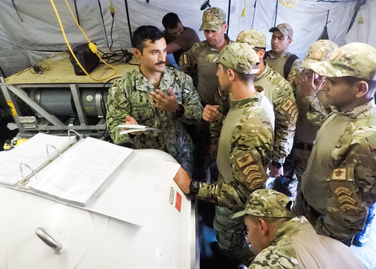 An American sailor deployed to U.S. 5th Fleet’s Task Group 52.3, left, and Egyptian sailors conduct a familiarization dive during Exercise Eagle Response 18 at Red Sea Naval Base, Egypt, July 25, 2018. Eagle Response 18 is an explosive ordnance disposal and diving exercise conducted with the Egyptian navy to enhance interoperability and warfighting readiness, fortify military-to-military relationships and advance operational capabilities of all participating units. Navy photo