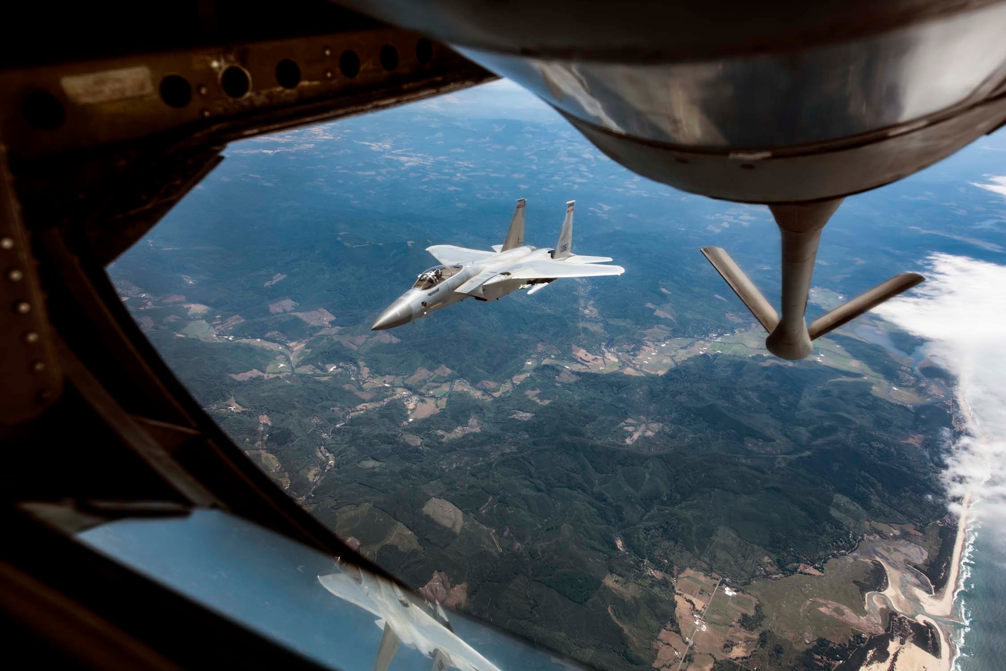 An F-15A Eagle from the 142nd Fighter Wing in Portland, Ore. Breaks away after receiving fuel from a KC-135 Stratotanker from the 141st Air Refueling Wing during Aerospace Control Alert CrossTell training exercise July 24, 2018 over western Oregon. CrossTell is a three-day exercise involving multiple Air National Guard units, the Civil Air Patrol, and U.S. Coast Guard rotary-wing air intercept units to conduct training scenarios to replicate airborne intercepts designed to safely escort violators out of restricted airspace. (U.S. Air National Guard photo by Staff Sgt. Rose M. Lust)