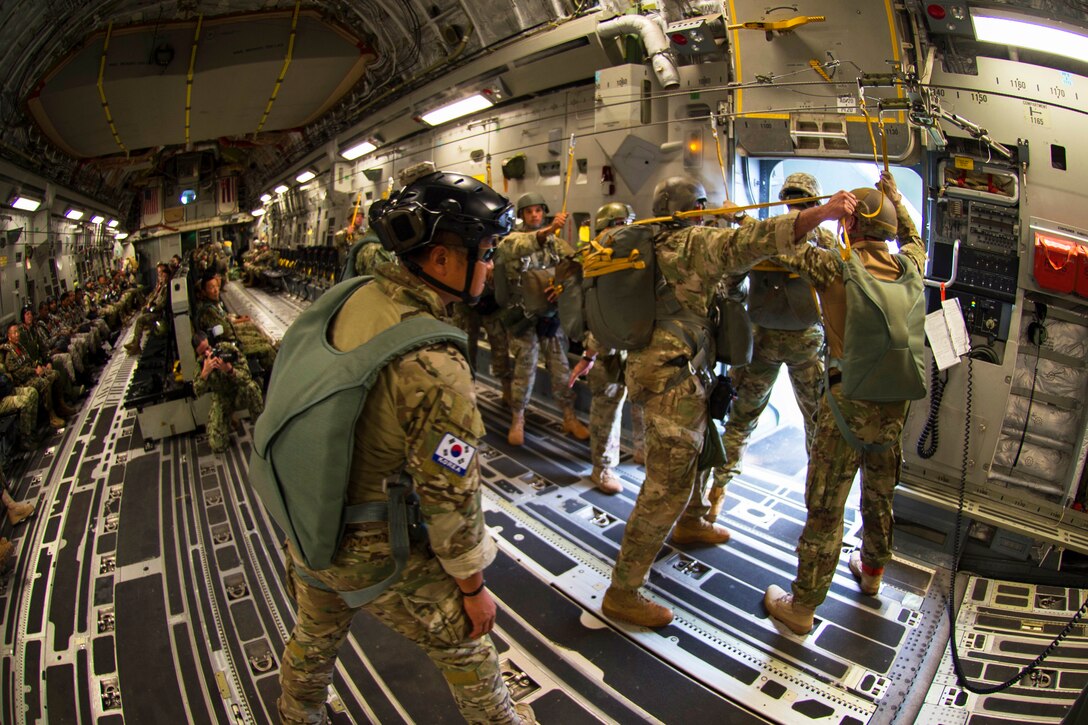 Soldiers practice free-fall parachute jumping during airborne training.