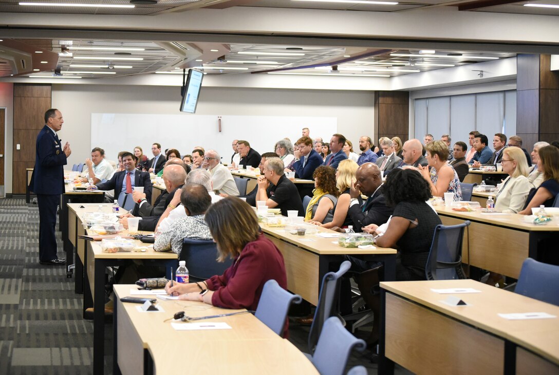 Lt. Gen. Lee K. Levy II, front, speaks at an event June 28 after being introduced by Daniel Pullin, dean of the University of Oklahoma Price College of Business. He was the inaugural speaker of a distinguished speaker series hosted at the Gene Rainbolt Graduate School of Business. His lecture centered on the theme of “Intersection of Innovation + Armed Services.”