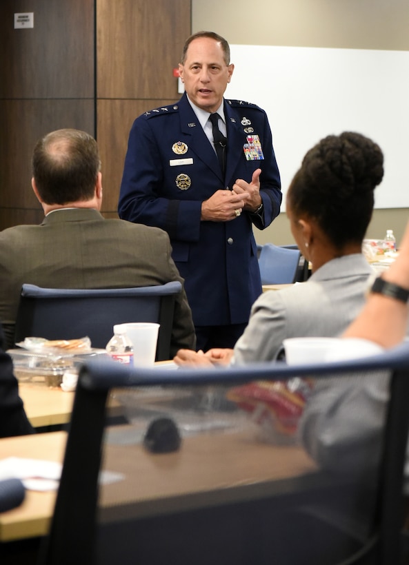 Lt. Gen. Lee K. Levy II, front, speaks at an event June 28 after being introduced by Daniel Pullin, dean of the University of Oklahoma Price College of Business. He was the inaugural speaker of a distinguished speaker series hosted at the Gene Rainbolt Graduate School of Business. His lecture centered on the theme of “Intersection of Innovation + Armed Services.”