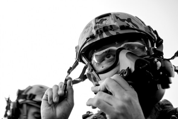 A U.S. Air Force Physiology technician temporarily assigned to the 19th Aerospace Medicine Squadron’s High Altitude Airdrop Mission Support unit buckles his oxygen mask as he prepares for a High Altitude, Low Open parachute jump from a C-130 Hercules at Little Rock Air Force Base, Arkansas, Nov. 16, 2016. (U.S. Air Force photo)