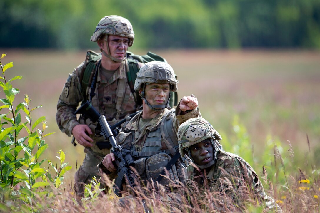 A soldier directs members of his squad to their follow-on objective.