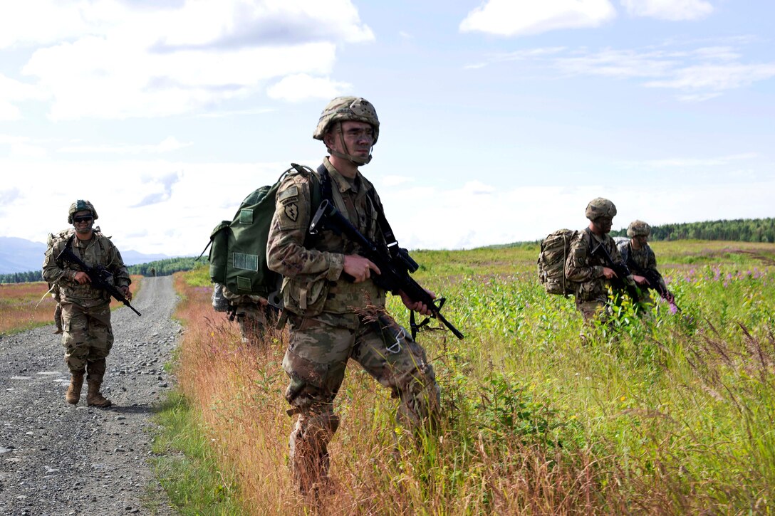 Soldiers maneuver to their follow-on objective after conducting an airborne operation.