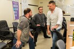 PSNS & IMF Electronic Shop employees Nick Omstead (left) and Tommy Kidwell (center) listen intently as Lawrence "Cowboy" Kalcso, a Production Reseources Department program analyst, explains an IPED stretch