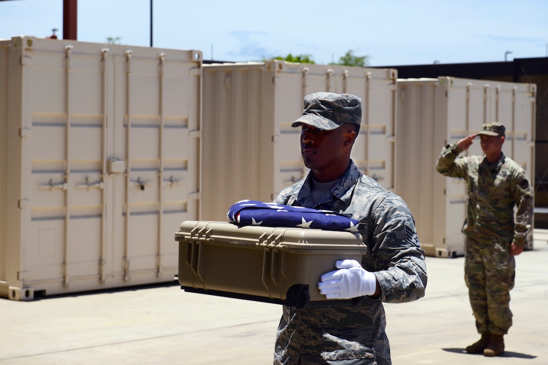 Air Force Staff Sgt. Sedric Franklin, assigned to the Defense POW/MIA Accounting Agency, conducts an honorable carry for the remains of an unidentified U.S. service member lost in the Korean War at Joint Base Pearl Harbor-Hickam, Hawaii, July 20, 2018.