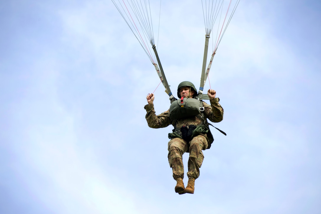 A U.S. soldier prepares to perform a parachute landing fall.