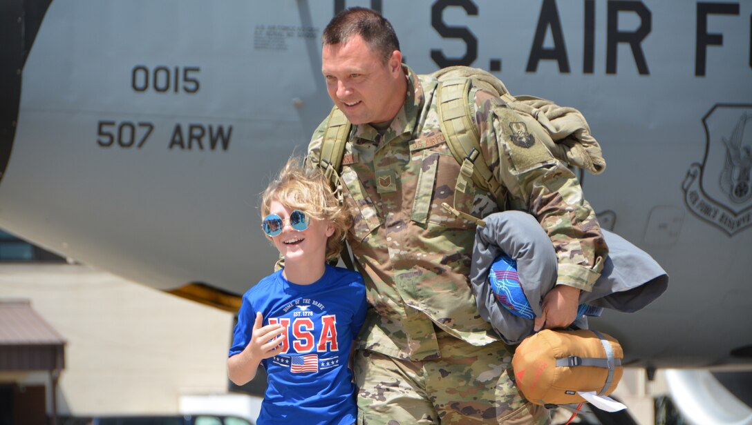 U.S. Air Force Tech. Sgt. Brian Jackson with the 507th Operations Support Squadron at Tinker Air Force Base, Oklahoma, reunites with his son following a deployment July 3, 2018. More than 100 Reserve Citizen Airmen from the 507th Air Refueling Wing at Tinker AFB deployed to Incirlik Air Base, Turkey, in support of air operations. (U.S. Air Force photo by Tech. Sgt. Samantha Mathison)