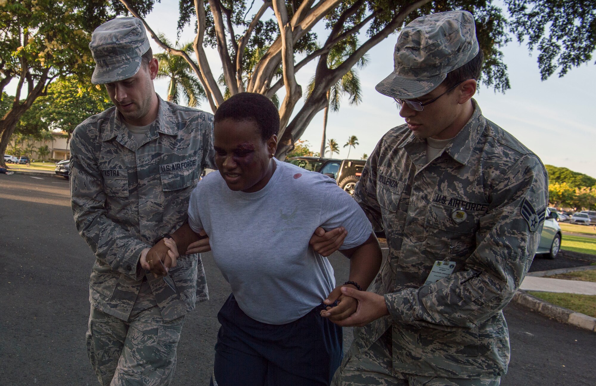 Senior Airman Logan Dykstra and Senior Airman Spencer Wollenzin, 15th Medical Group, provide aid to Staff Sgt. Nyasia Clark during a mass-casualty scenario for Rim of the Pacific exercise at Joint Base Pearl Harbor-Hickam, July 12, 2018. Twenty-five nations, 46 ships, five submarines, about 200 aircraft and 25,000 personnel are participating in RIMPAC from June 27 to Aug. 2 in and around the Hawaiian Islands and Southern California. The world’s largest international maritime exercise, RIMPAC provides a unique training opportunity while fostering and sustaining cooperative relationships among participants critical to ensuring the safety of sea lanes and security of the world’s oceans. RIMPAC 2018 is the 26th exercise in the series that began in 1971. (U.S. Air Force photo by Tech. Sgt. Heather Redman)