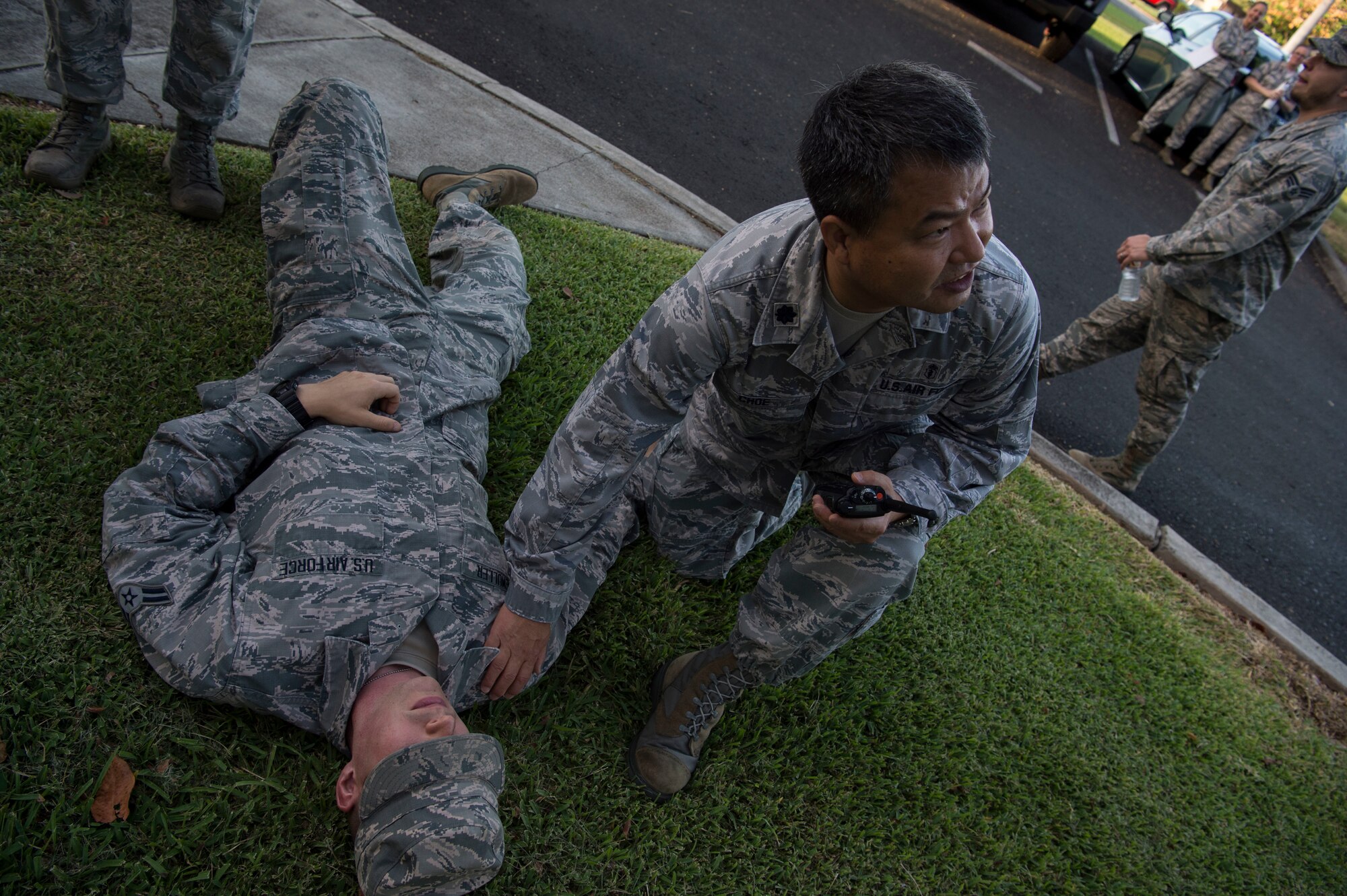 Lt. Col. Haeoh Choe, 15th Wing Medical Group, provides aid to Airman 1st Class Wayne Biemuller during a mass-casualty scenario for Rim of the Pacific exercise at Joint Base Pearl Harbor-Hickam, July 12, 2018. Twenty-five nations, 46 ships, five submarines, about 200 aircraft and 25,000 personnel are participating in RIMPAC from June 27 to Aug. 2 in and around the Hawaiian Islands and Southern California. The world’s largest international maritime exercise, RIMPAC provides a unique training opportunity while fostering and sustaining cooperative relationships among participants critical to ensuring the safety of sea lanes and security of the world’s oceans. RIMPAC 2018 is the 26th exercise in the series that began in 1971. (U.S. Air Force photo by Tech. Sgt. Heather Redman)