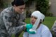 Senior Airman Samantha King, 15th Medical Group, bandages Capt. Elizabeth Perryman’s simulated wounds during a mass-casualty scenario for Rim of the Pacific  exercise at Joint Base Pearl Harbor-Hickam, July 12, 2018. Twenty-five nations, 46 ships, five submarines, about 200 aircraft and 25,000 personnel are participating in RIMPAC from June 27 to Aug. 2 in and around the Hawaiian Islands and Southern California. The world’s largest international maritime exercise, RIMPAC provides a unique training opportunity while fostering and sustaining cooperative relationships among participants critical to ensuring the safety of sea lanes and security of the world’s oceans. RIMPAC 2018 is the 26th exercise in the series that began in 1971. (U.S. Air Force photo by Tech. Sgt. Heather Redman)